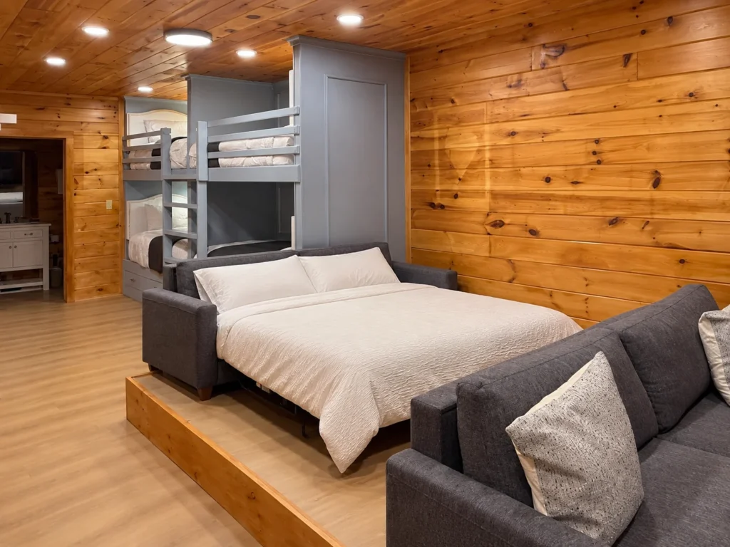 A sofa bed opened in the entertainment room, beside the built-in bunks.