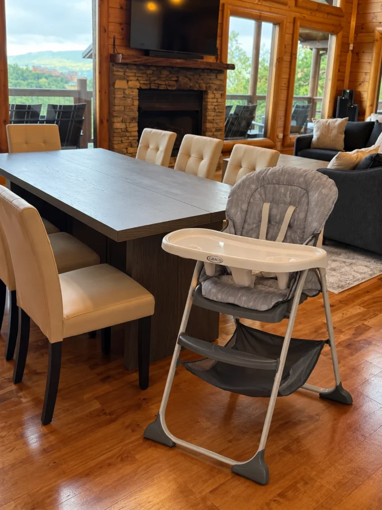 The high chair beside the family dining table and great-room fireplace.