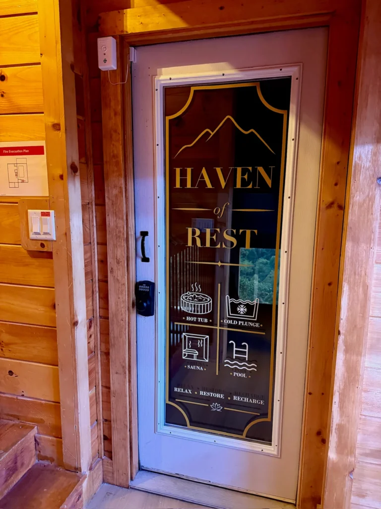 The Haven of Rest door marks the entrance to the cabin’s pool and spa space.