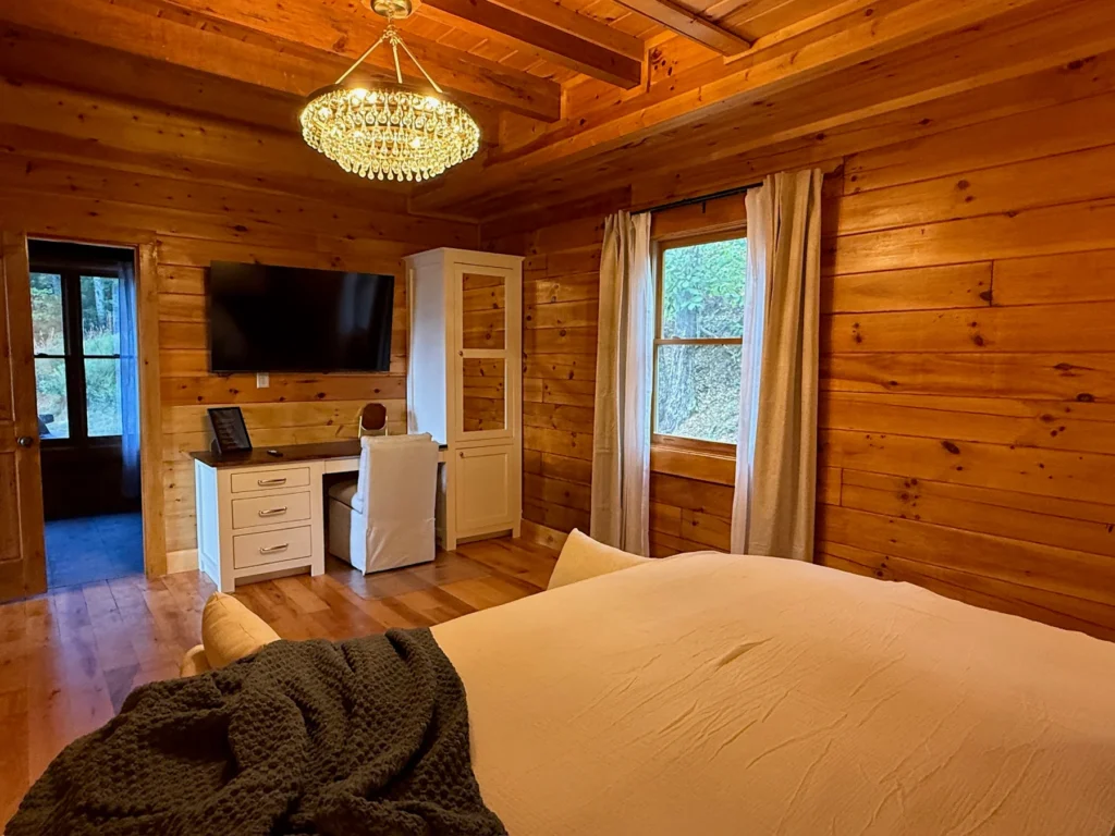 A king bedroom with a dedicated desk, TV and storage cabinet.