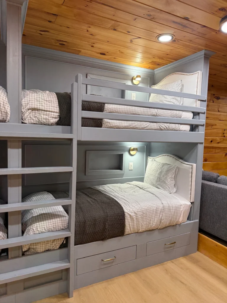 A close view of the bunk-room ladder, bedside cubbies and storage drawers.