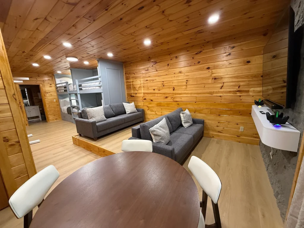 A game table, sofas and TV in the lower-level entertainment space.