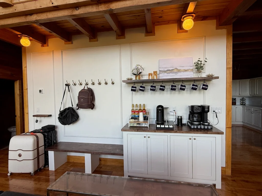 The coffee bar sits beside entry hooks, a storage bench and space for luggage.