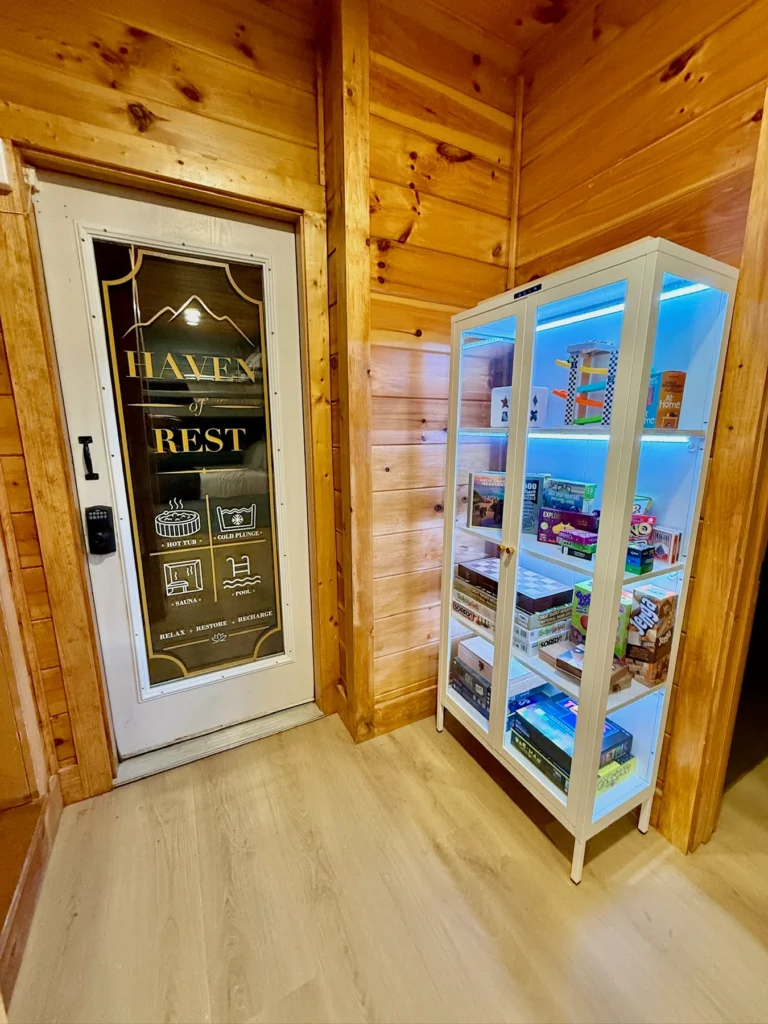 A stocked game cabinet beside the spa-room entrance.