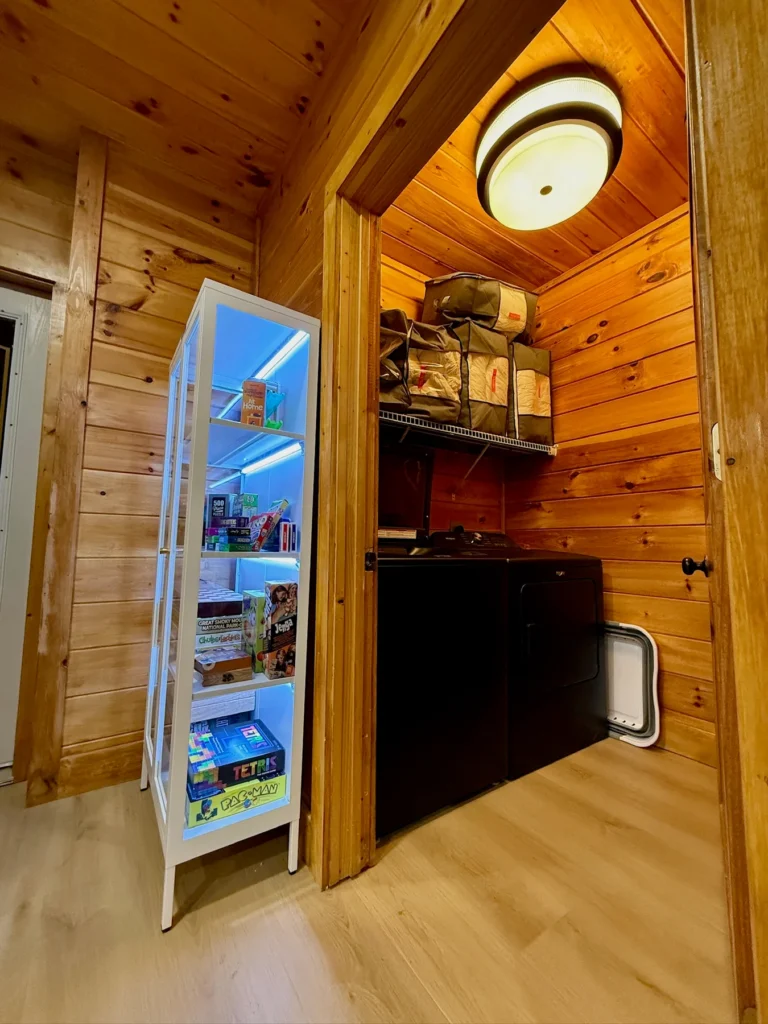 The full-size laundry room beside the stocked board-game cabinet.