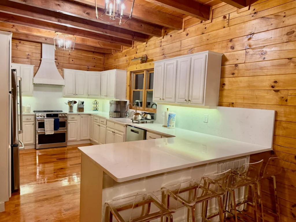 White cabinetry, stainless-steel appliances and breakfast-bar seating.