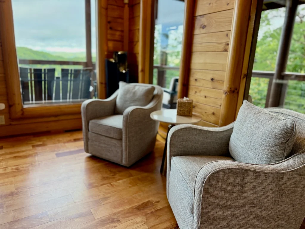 Two upholstered chairs beside the tall great-room windows.