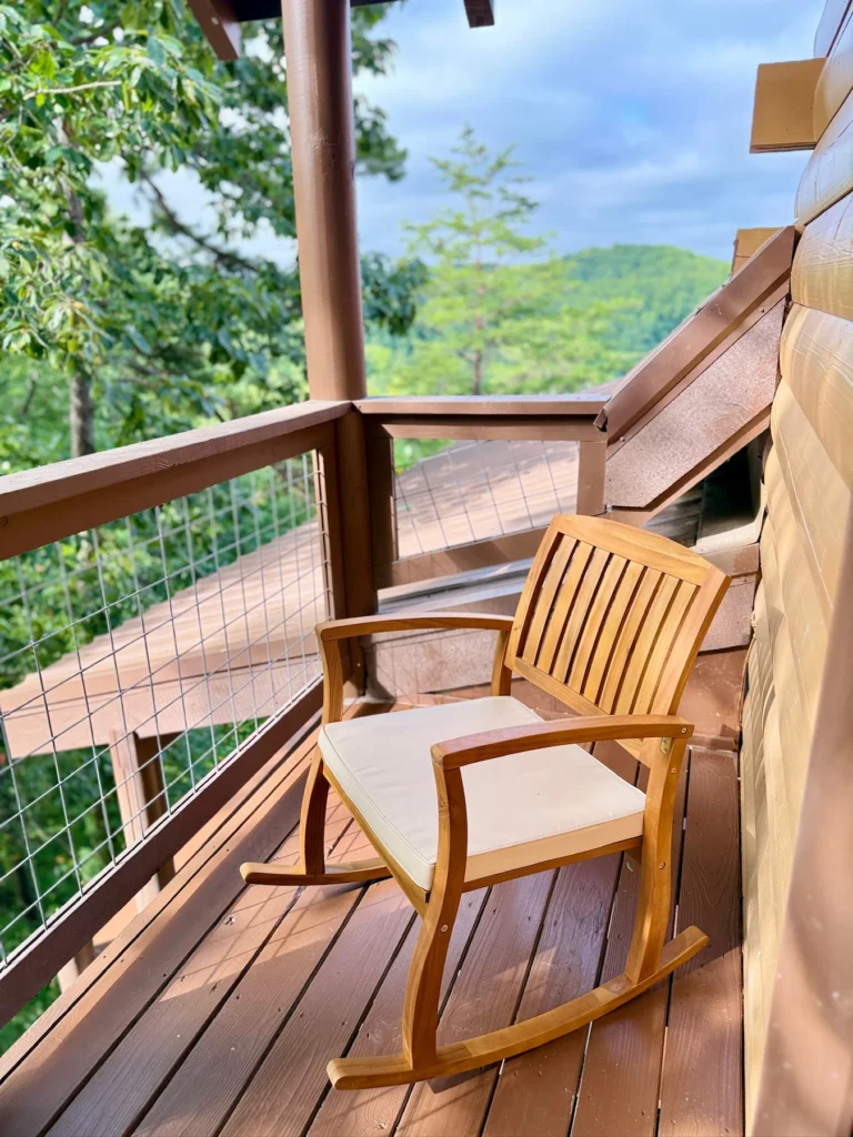 Two rocking chairs beside the timber wall on the covered upper deck.