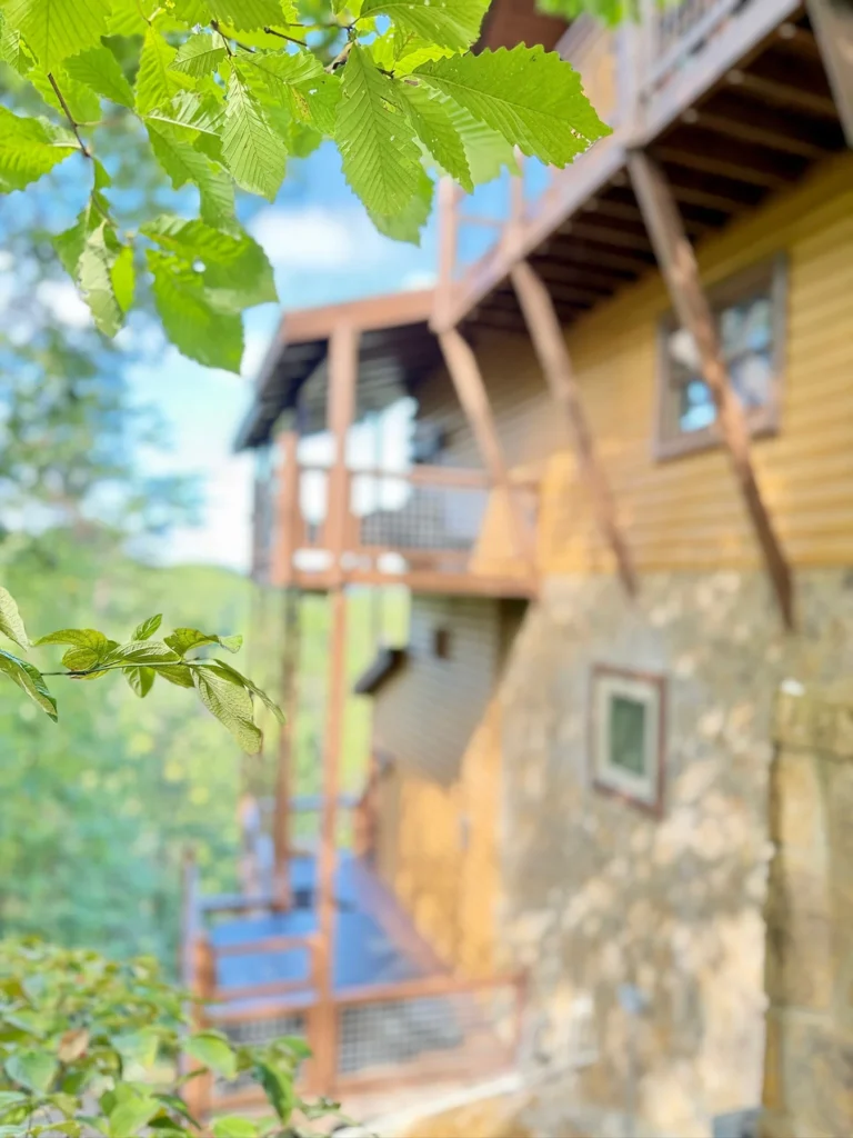 A close exterior view of the timber decks and stone lower level.
