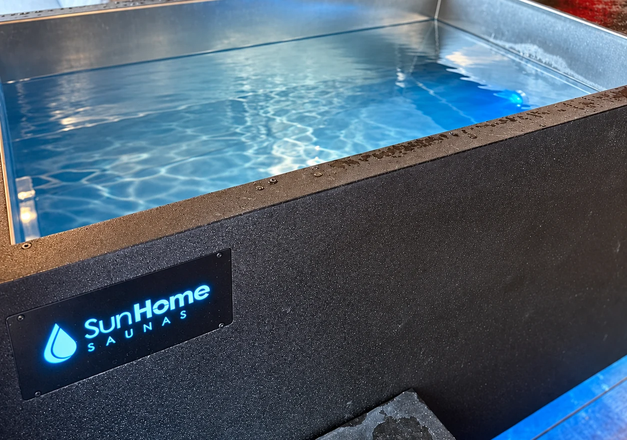 Clear water and blue underwater lighting inside the Sun Home cold plunge.
