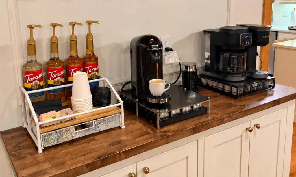 Coffee bar with Nespresso and Keurig machines, syrups and tea supplies.