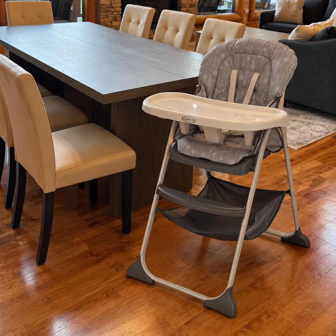 A high chair beside the dining table.